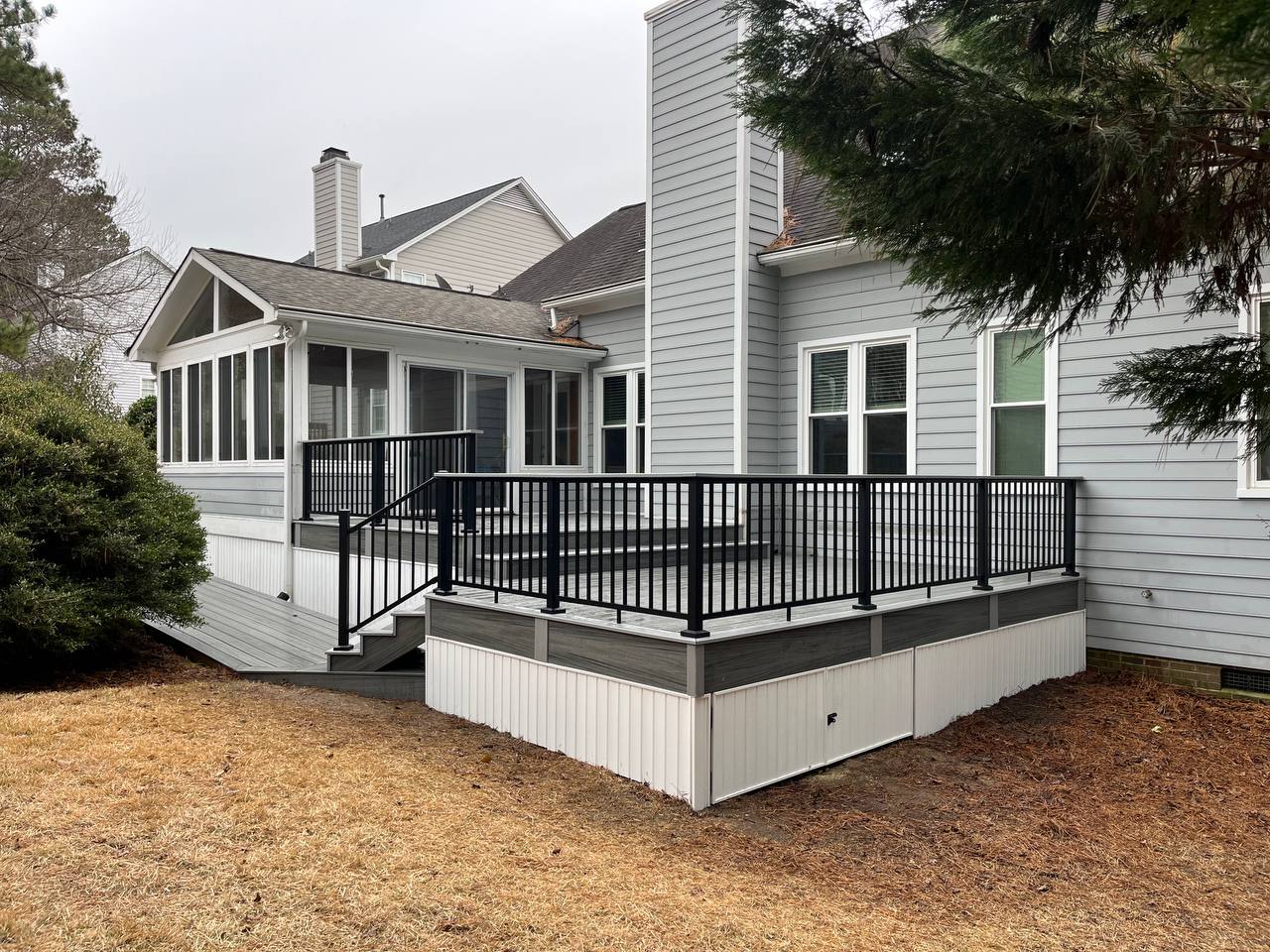 Composite deck with black aluminum railing on residential home
