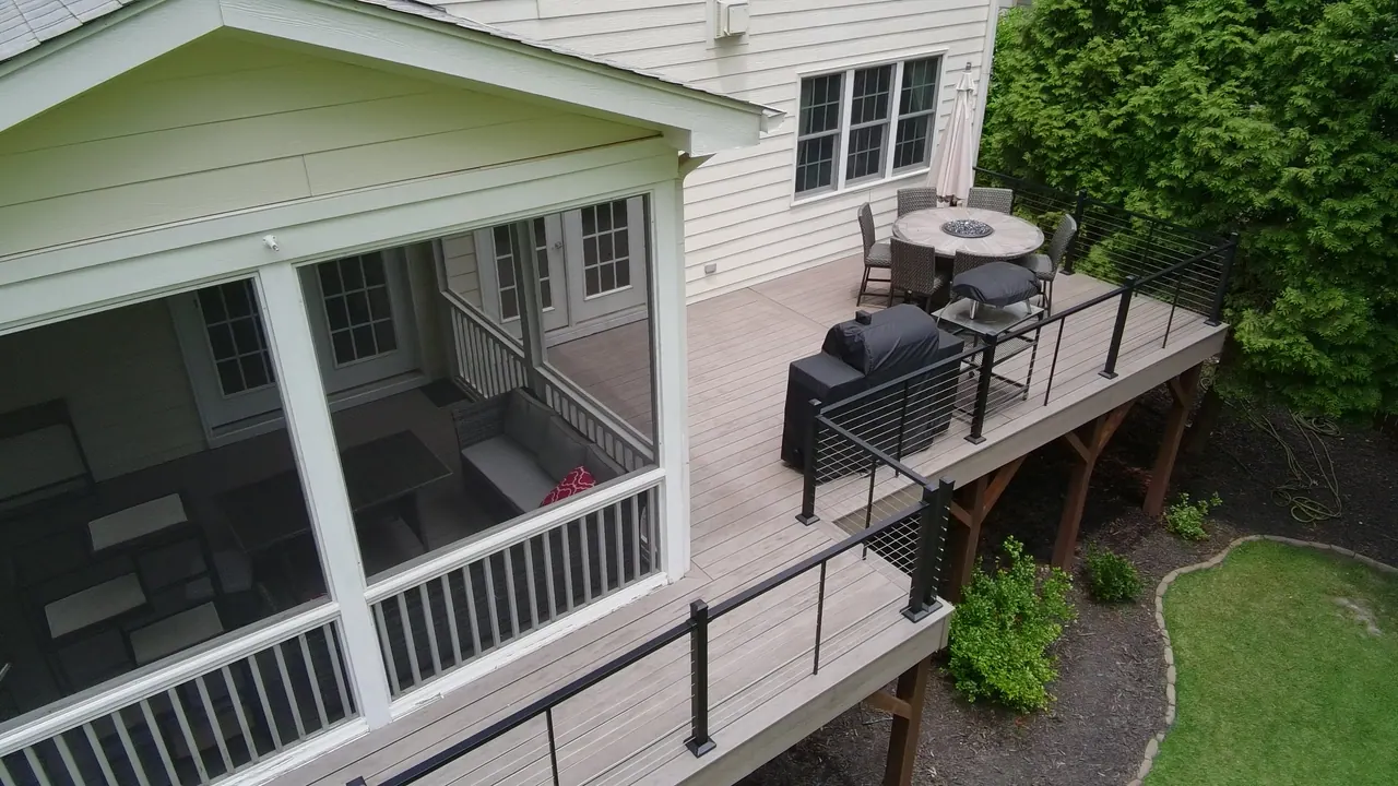 Screened porch and composite deck with black railing on a Triangle home